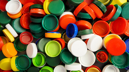 Close up of red, white, blue, yellow and green caps from plastic bottles. plastic collection. copy space. view from above