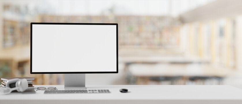 A white-screen computer mockup on a table with a blurred background of a contemporary library.