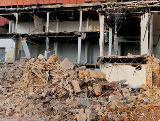 the earthquakes destroyed the houses and they are now being cleared away by excavators with special pliers for cutting wires and crushing concrete. rescue work apartment building complex