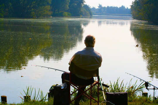 Man fishing with a rod in a lake in the Netherlands