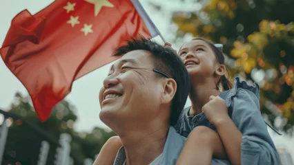 Fototapeten Radiant Chinese Family Waving Flags of Their Nation © Andriy