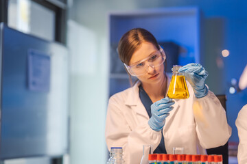 A female scientist conducts data analysis in a laboratory, research on medical equipment for chemistry analysis. healthcare diagnostics and treatments, vaccine, medicine.