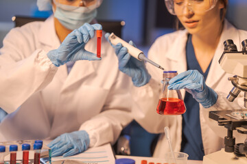 A female scientist conducts data analysis in a laboratory, research on medical equipment for chemistry analysis. healthcare diagnostics and treatments, vaccine, medicine.