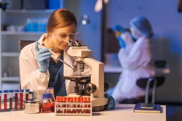 A female scientist conducts data analysis in a laboratory, research on medical equipment for...
