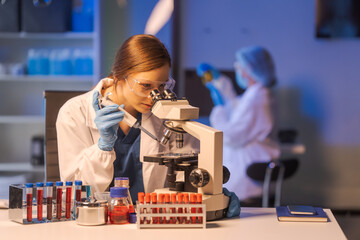 A female scientist conducts data analysis in a laboratory, research on medical equipment for...