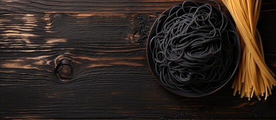 A close up of a bowl of pasta on a wooden table