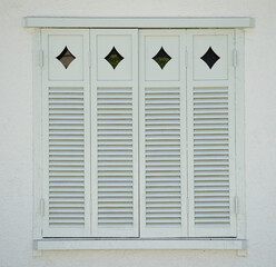 White window shutters on the exterior of the room of the house
