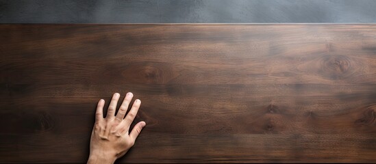 Hand on wooden tabletop