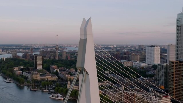 Parallax effect orbit drone shot around tip of Erasmusbridge Rotterdam