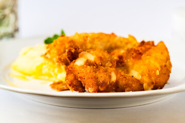 Fried schnitzel in breadcrumb with almonds, mashed potato. - 763864349