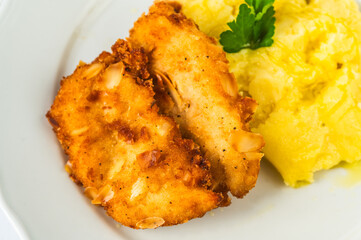 Fried schnitzel in breadcrumb and almond, mashed potato. - 763864546