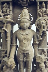  A finely detailed stone sculpture of a Jain Tirthankara Parshvanatha,  with a serene expression, surrounded by ornate carvings