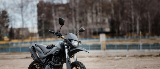 custom homemade motard enduro motorcycle for city and off-road riding in matte black color.