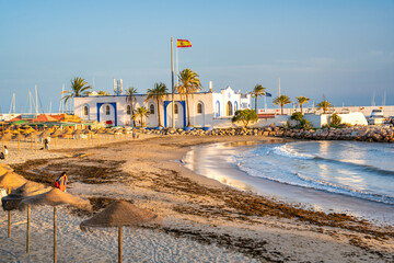 Marbella, Spain - April 5, 2023: City beach at sunset with tourists