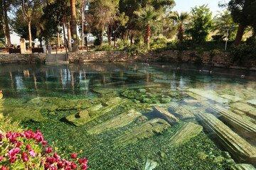 The famous Cleopatra Pool in the early morning, hot spring with submerged roman columns inside,...