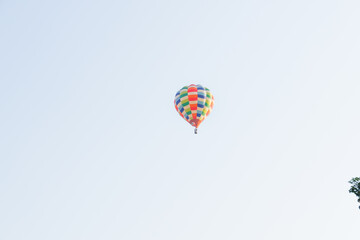 Hot air balloons landing in a mountain flight over field and forest,colorful Hot air balloons flying over the valley with blue sky,Tourism concept.