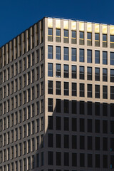 Facade of modern building. Bright sunlight  and blue sky background.