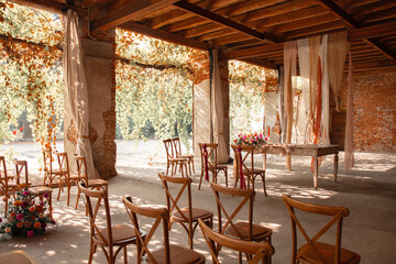 Wedding site with chairs and flowers. Italian wedding decoration.