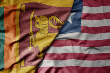 big waving national colorful flag of liberia and national flag of sri lanka .