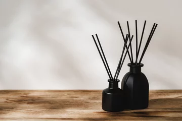 Fotobehang Minimalist Aromatic Reed Diffusers on a Wooden Surface Against a Soft Background © fotofabrika