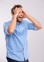 Stress, screaming or man with hands on face in studio for mental health, crisis or mistake on white background. Anxiety, overthinking or male model with bad reaction to news, disaster or broken heart