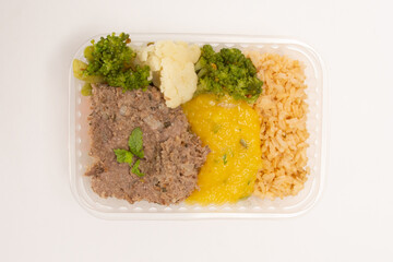 Healthy meat packed lunch box meal in front top aerial view clean white background