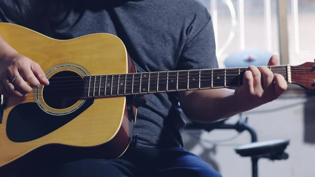 Hands of guitarist playing a guitar. man playing guitar and chord guitar. Footage b-roll 4k.