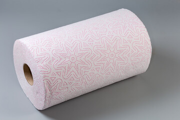 Roll of tear-off paper towels on a gray surface