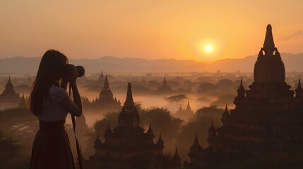 an adventurous female photographer silhouetted against the rising sun as she captures the essence of historic temples