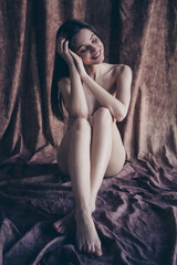 Obraz na płótnie Canvas Photo no filter of cute tender girl sitting silky linen floor feeling body positive isolated studio background