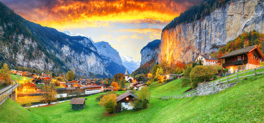 Captivating autumn view of Lauterbrunnen valley with gorgeous Staubbach waterfall and Swiss Alps at sunset time