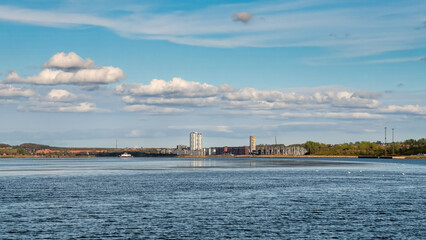 Aalborg and N&oslash;rresundby skyline along Limfjord under blue sky, Nordjylland, Denmark