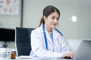 Portrait of mix race asian middle age female doctor in white lab coat and stethoscope while consult...
