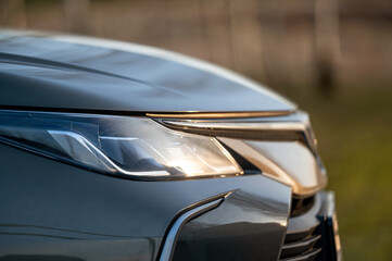 Close up of the headlight of a modern car, shallow depth of field - obrazy, fototapety, plakaty