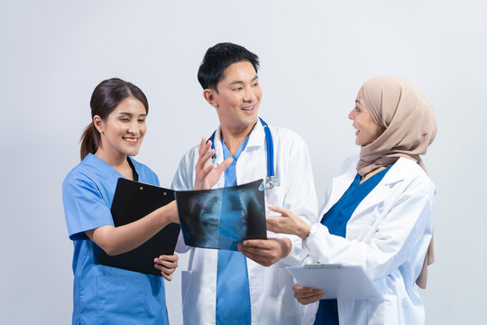 Team meeting group of doctor multi ethnic people, Multiracial medical team discussing x-ray film of MRI scan data in conference room at hospital or clinic. To study and research cancer treatment