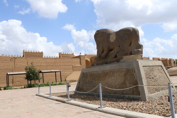 Several perspectives of the Lion of Babylon statue in the ancient city of Babylon on a cloudy day