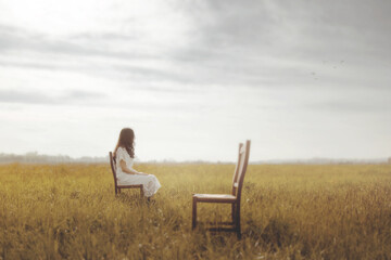 sad sitting woman turns away from lover's empty chair, future concept