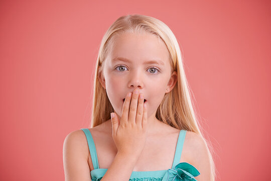 Wow, surprise and portrait of girl in studio with hand on mouth for secret, gossip or news on pink background. Omg, face and kid model with oops emoji, shock or announcement, promo or unexpected info