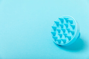 Brush for scalp massage on background. Brush for hair growth stimulating brush. Hair massage. stimulating brush. Hair care, head relaxation concept. Copy space.