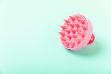 Brush for scalp massage on background. Brush for hair growth stimulating brush. Hair massage. stimulating brush. Hair care, head relaxation concept. Copy space.