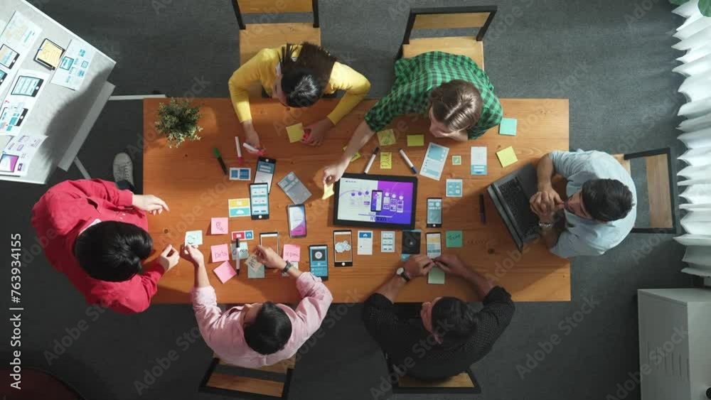 Poster top view of developer team working together to write idea about ux ui design on colorful sticky note