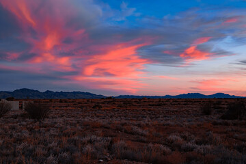 Fototapeta premium Crimson Sky Over Desert Terrain
