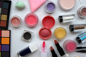 Various colorful beauty products on white background. Flat lay.