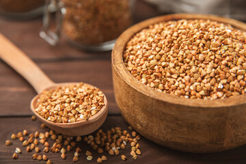 Green buckwheatin  on a wooden kitchen table.Superfood.Raw buckwheat porridge.Healthy vegan food concept, eco products, diet. Copy space.Organic food.weight loss and proper nutrition.