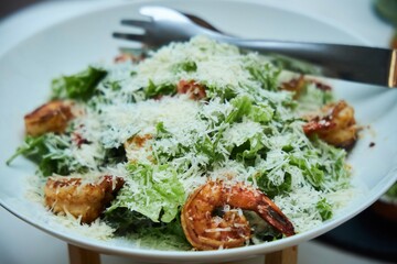 Salad with cheese and seafood on the festive table.
