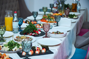A festive table of various dishes in a cafe or restaurant