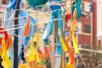 Hanging Firecrackers of different colors during the mascleta, a tradition of the city of Valencia