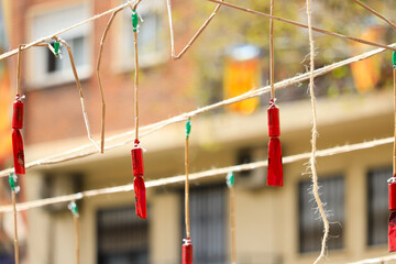Hanging Firecrackers of different colors during the mascleta, a tradition of the city of Valencia