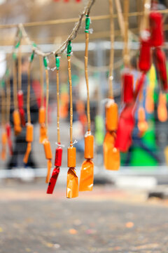 Hanging Firecrackers of different colors during the mascleta, a tradition of the city of Valencia