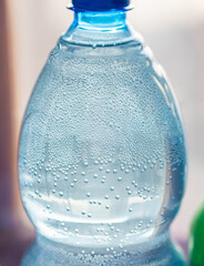Oxygen bubbles in the bottle with water or drink. Selective focus.